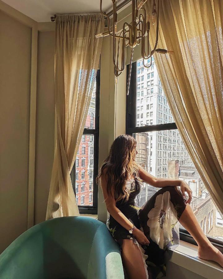 The Evelyn Nomad Hotel New York City Exterior photo A woman in a hotel room