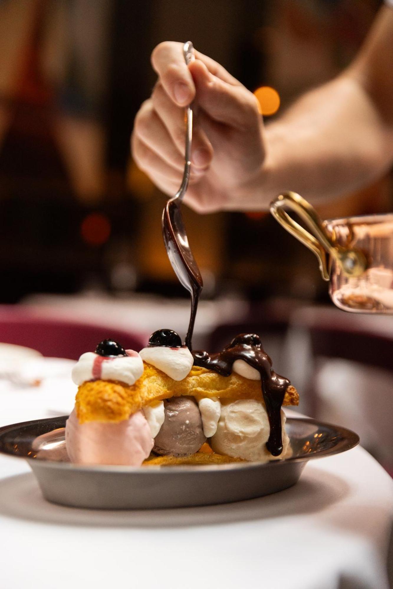 The Evelyn Nomad Hotel New York City Exterior photo Chocolate syrup being drizzled over a dessert