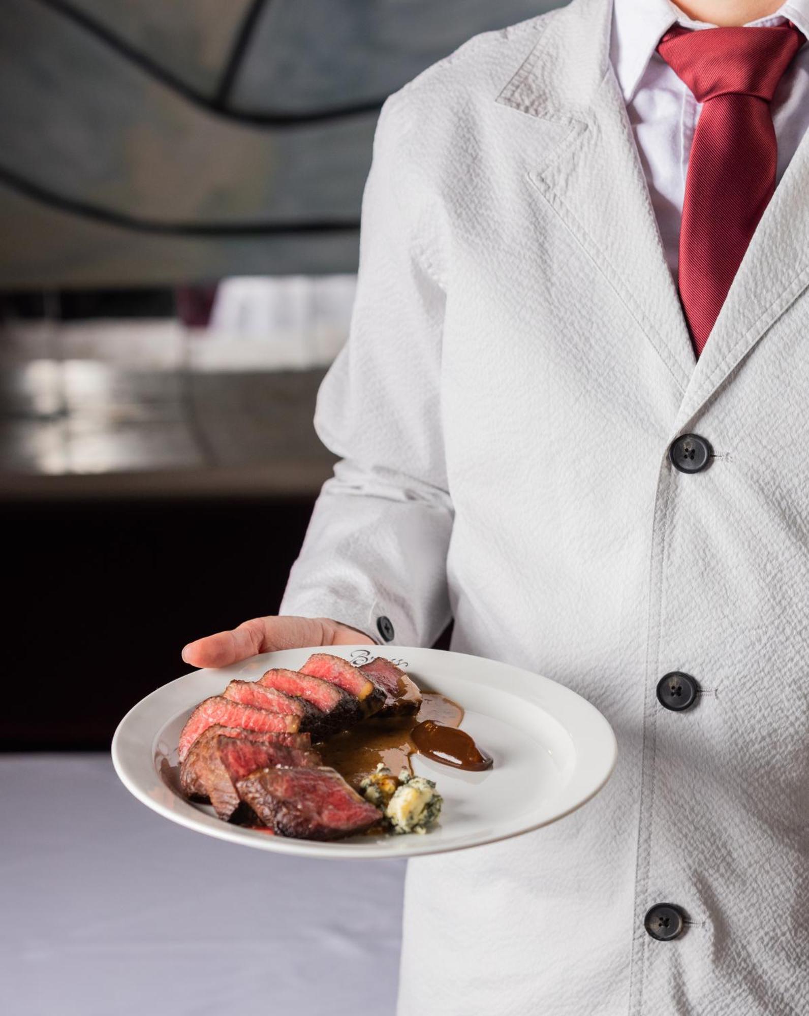 The Evelyn Nomad Hotel New York City Exterior photo A waiter serving a steak